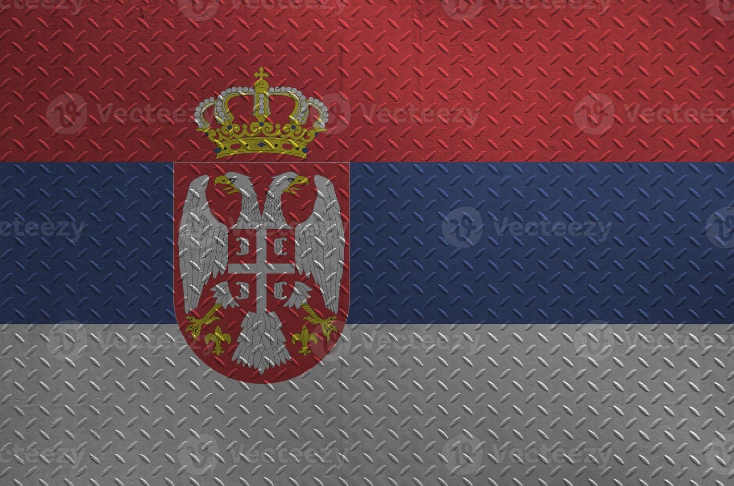 Serbia flag depicted in paint colors on old brushed metal plate or wall closeup. Textured banner on rough background photo