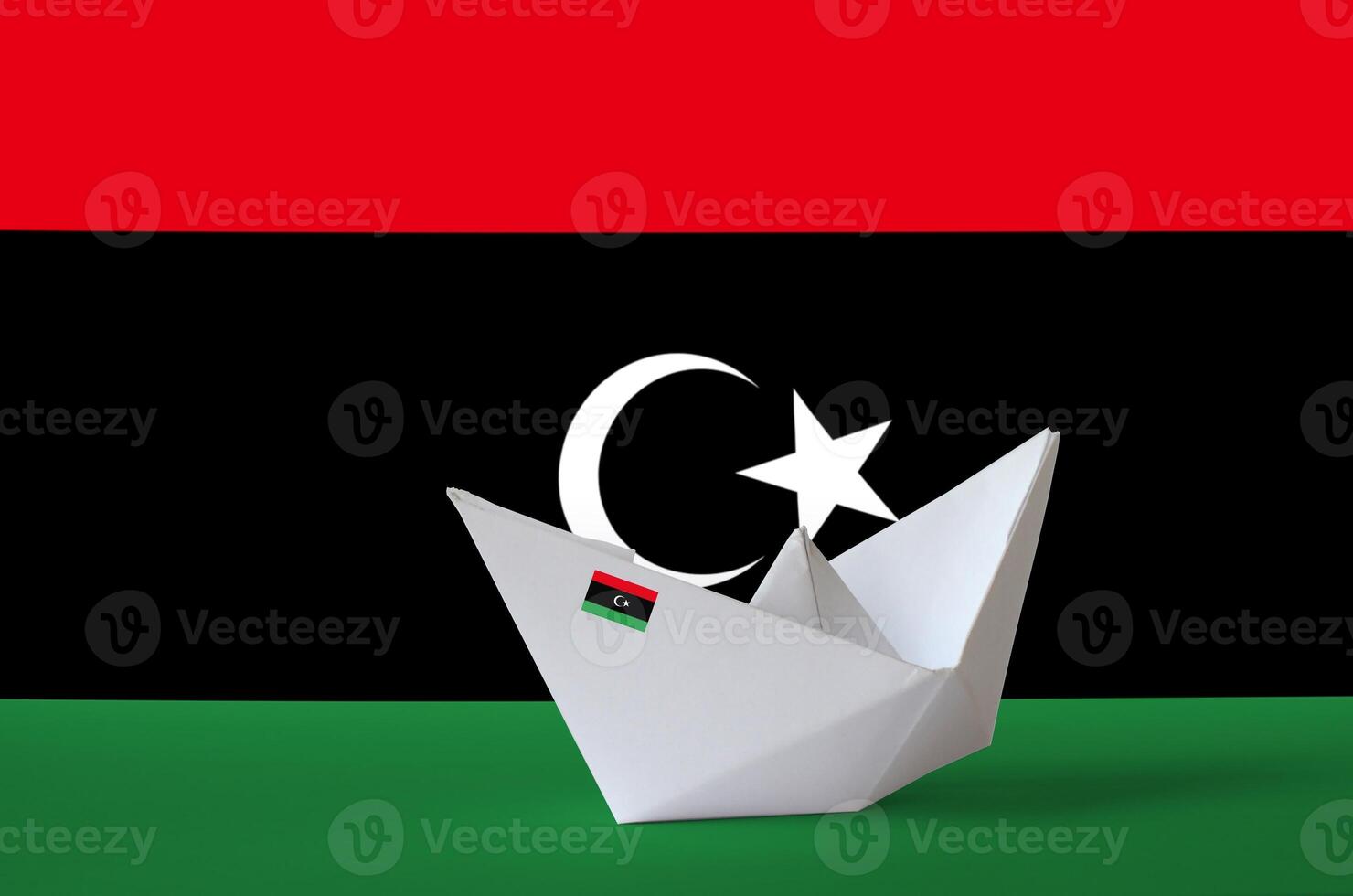 Libya flag depicted on paper origami ship closeup. Handmade arts concept photo