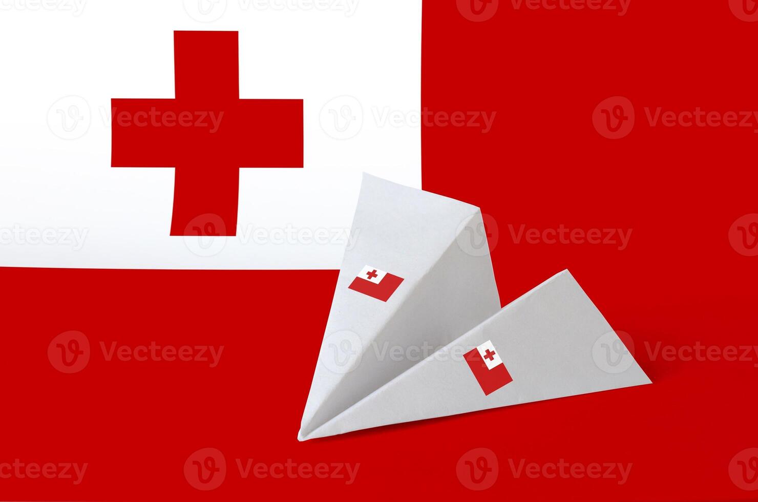 Tonga flag depicted on paper origami airplane. Handmade arts concept photo