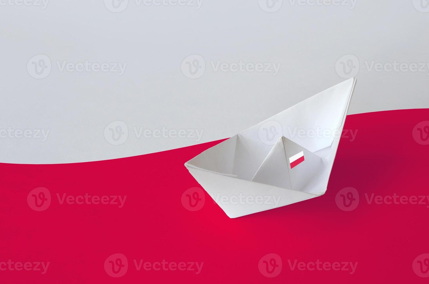Poland flag depicted on paper origami ship closeup. Handmade arts concept photo