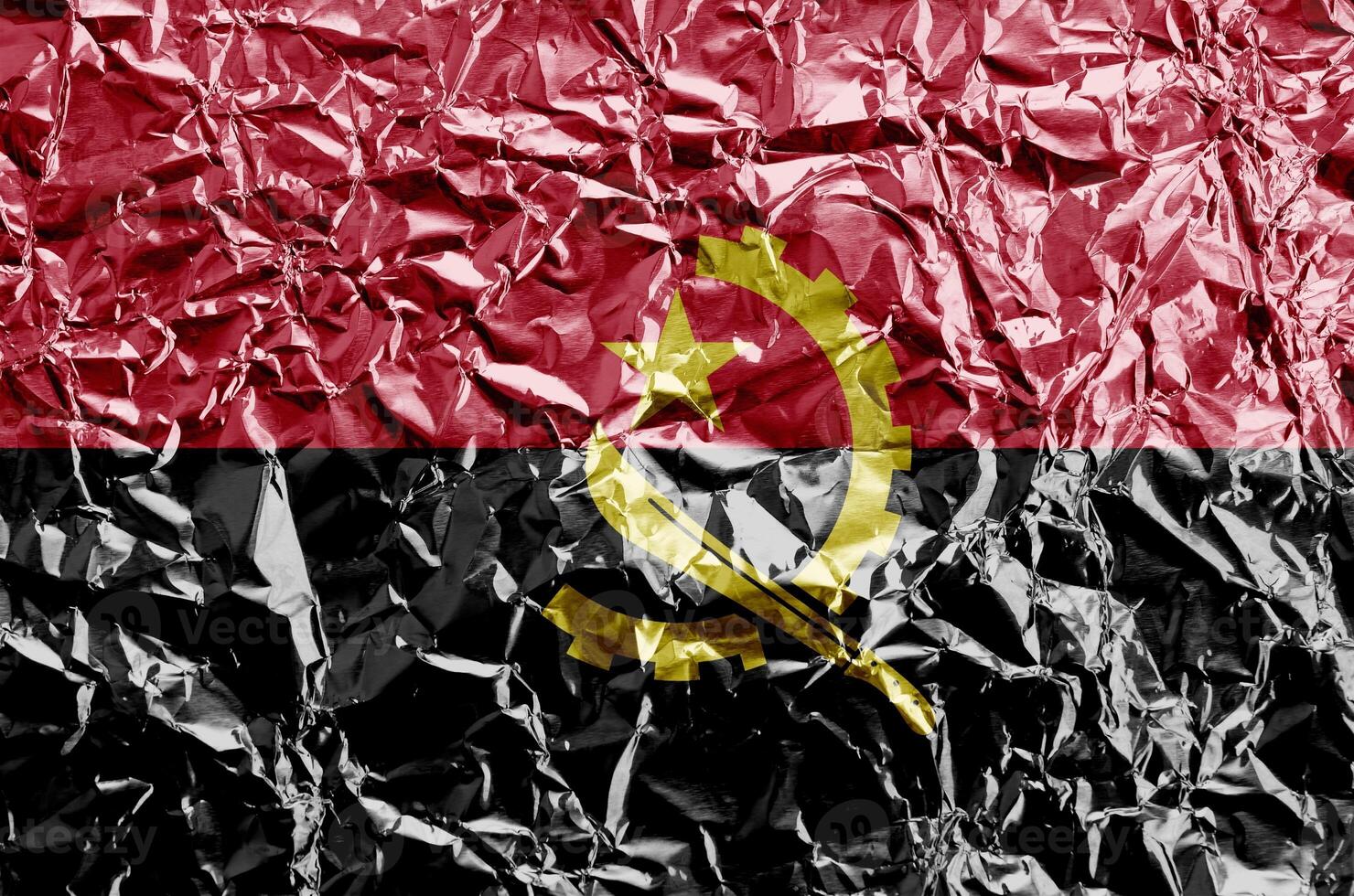 Angola flag depicted in paint colors on shiny crumpled aluminium foil closeup. Textured banner on rough background photo