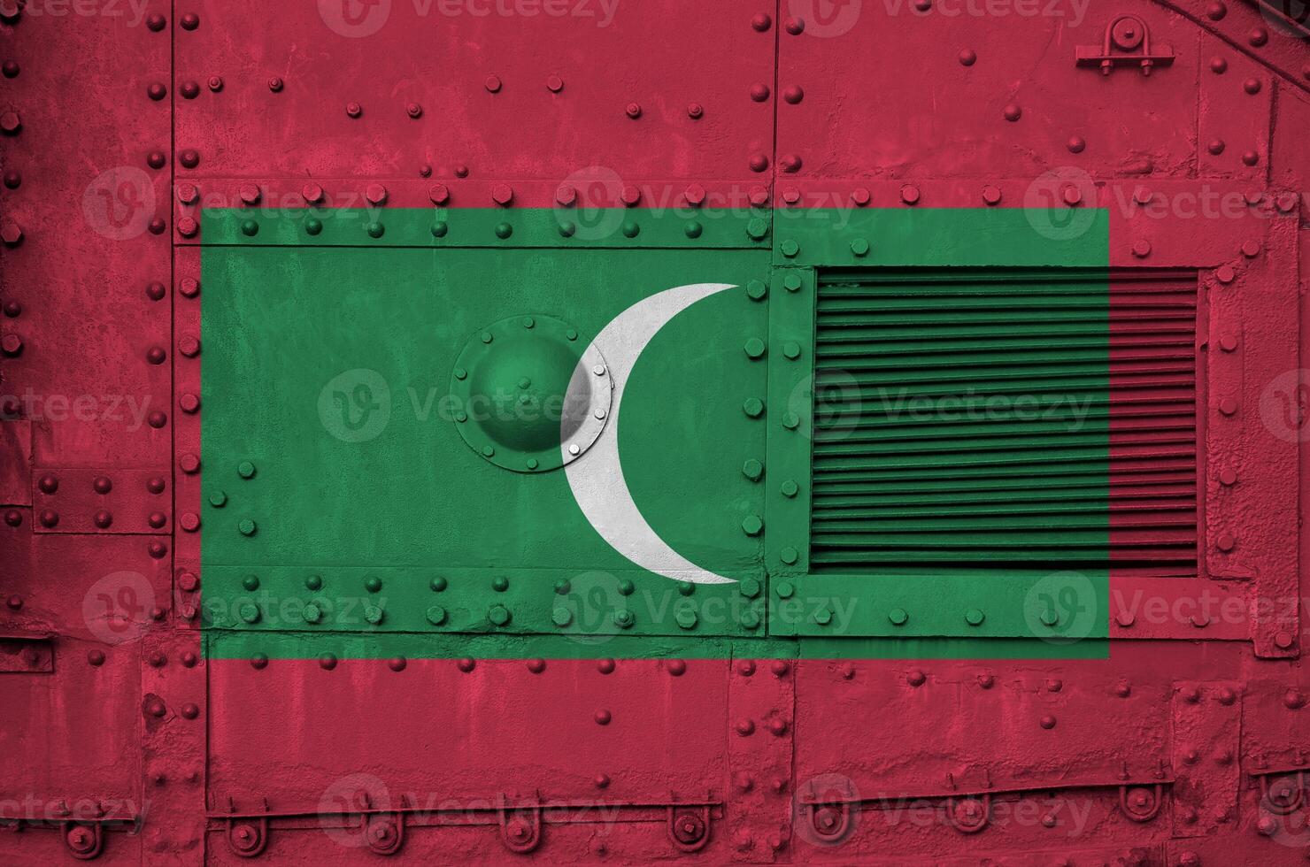 Maldives flag depicted on side part of military armored tank closeup. Army forces conceptual background photo