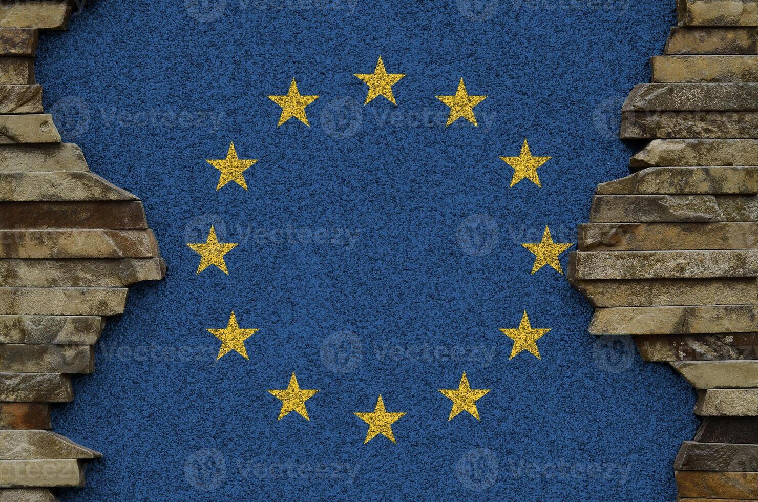 European union flag depicted in paint colors on old stone wall closeup. Textured banner on rock wall background photo
