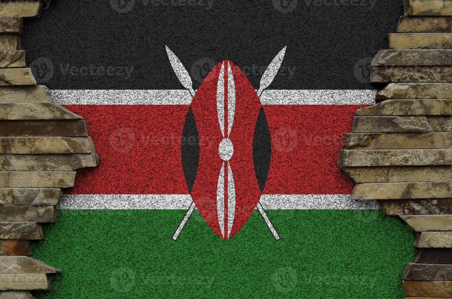 Kenya flag depicted in paint colors on old stone wall closeup. Textured banner on rock wall background photo