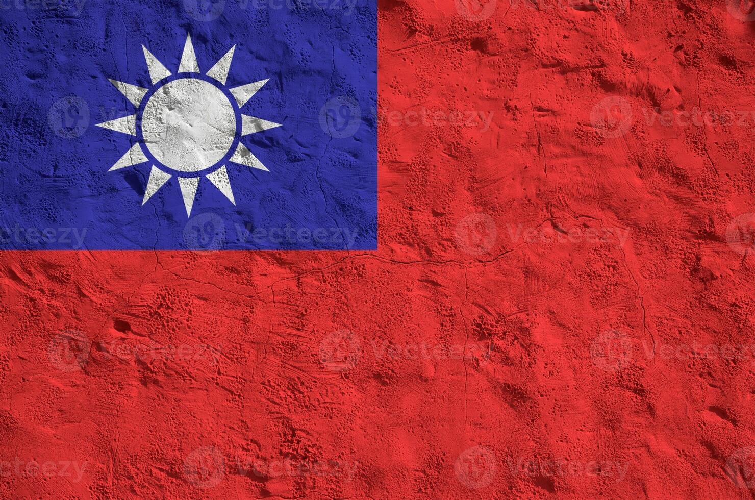 Taiwan flag depicted in bright paint colors on old relief plastering wall. Textured banner on rough background photo