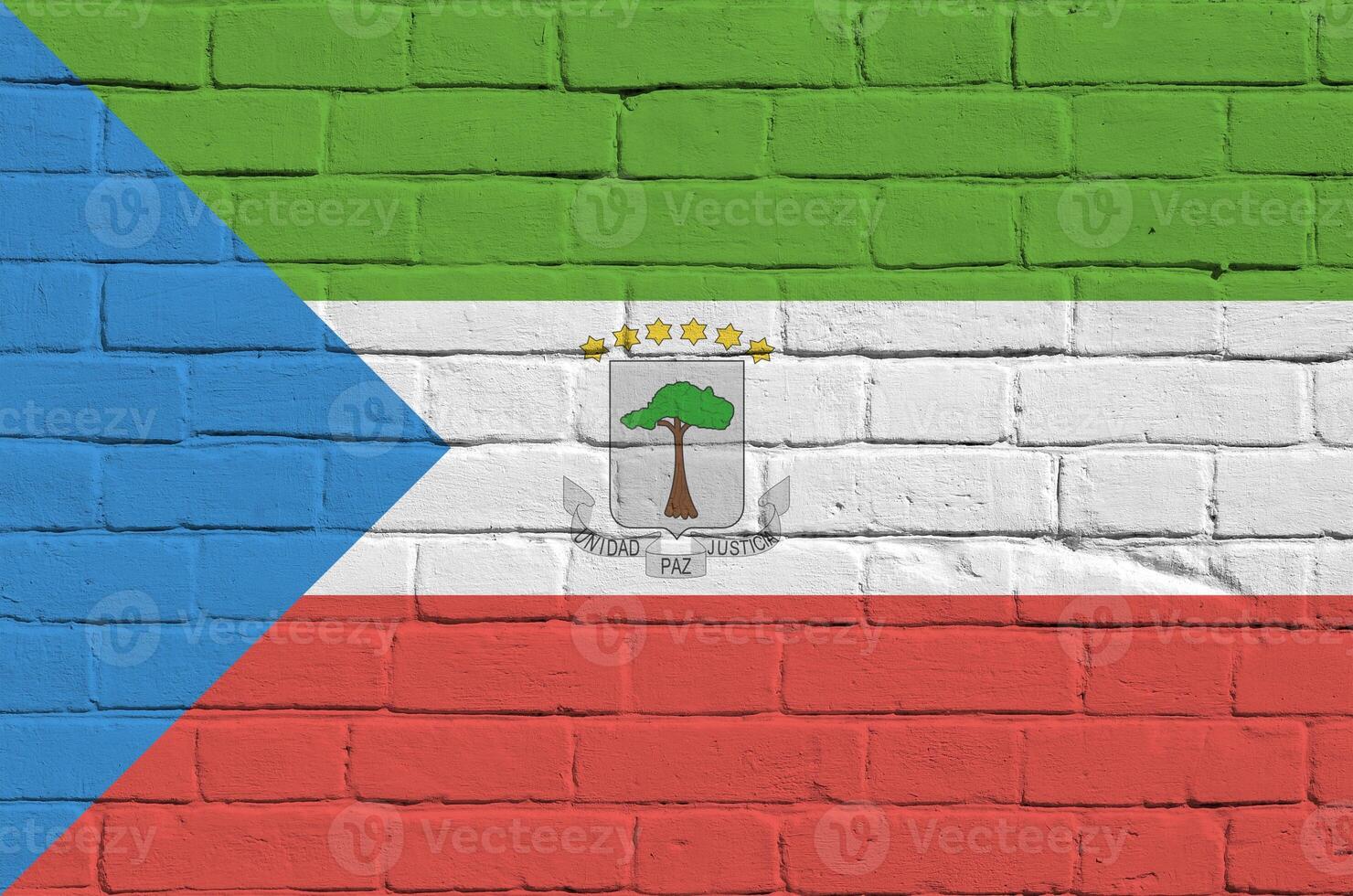 Equatorial Guinea flag depicted in paint colors on old brick wall. Textured banner on big brick wall masonry background photo