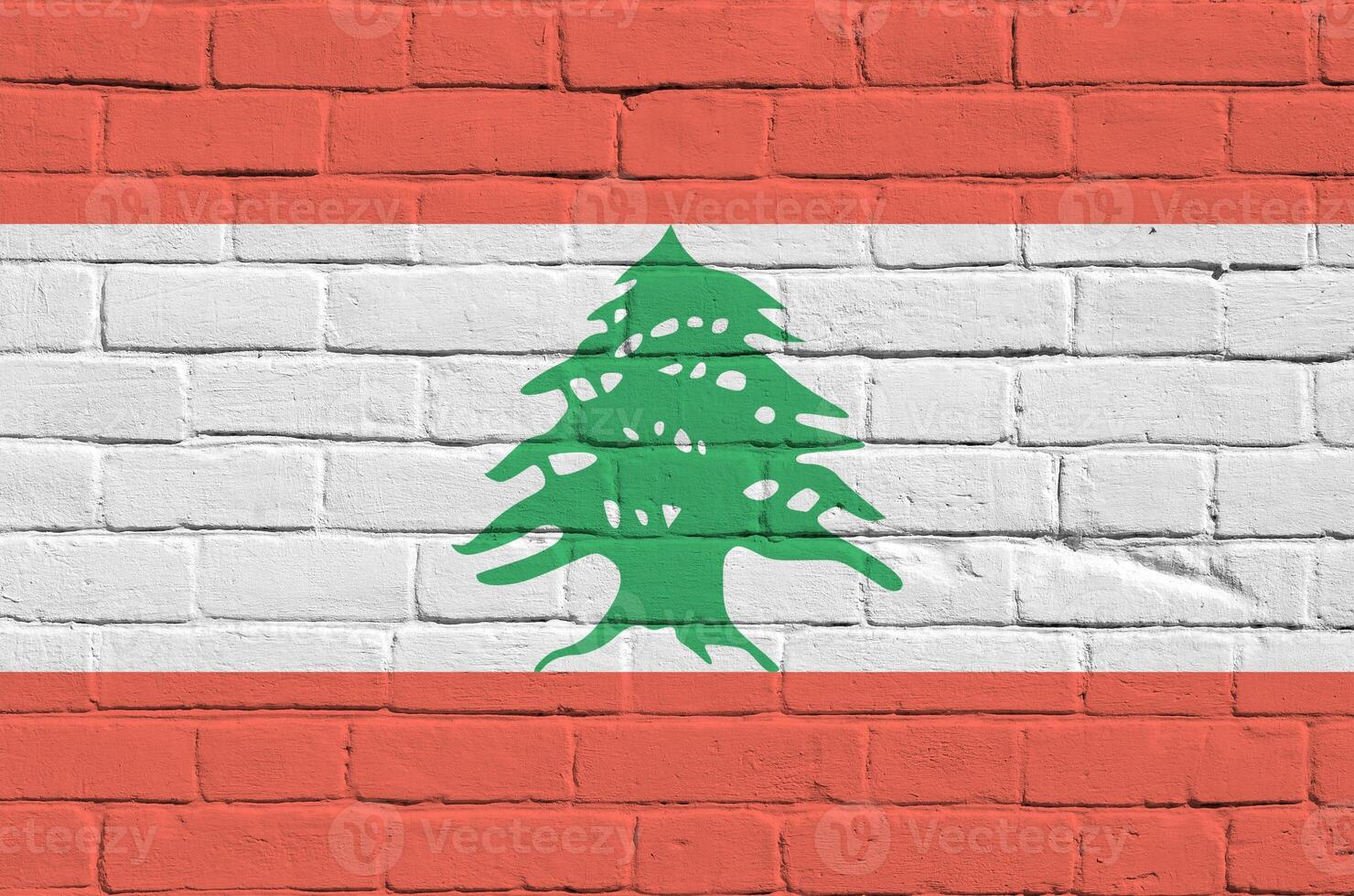 Lebanon flag depicted in paint colors on old brick wall. Textured banner on big brick wall masonry background photo