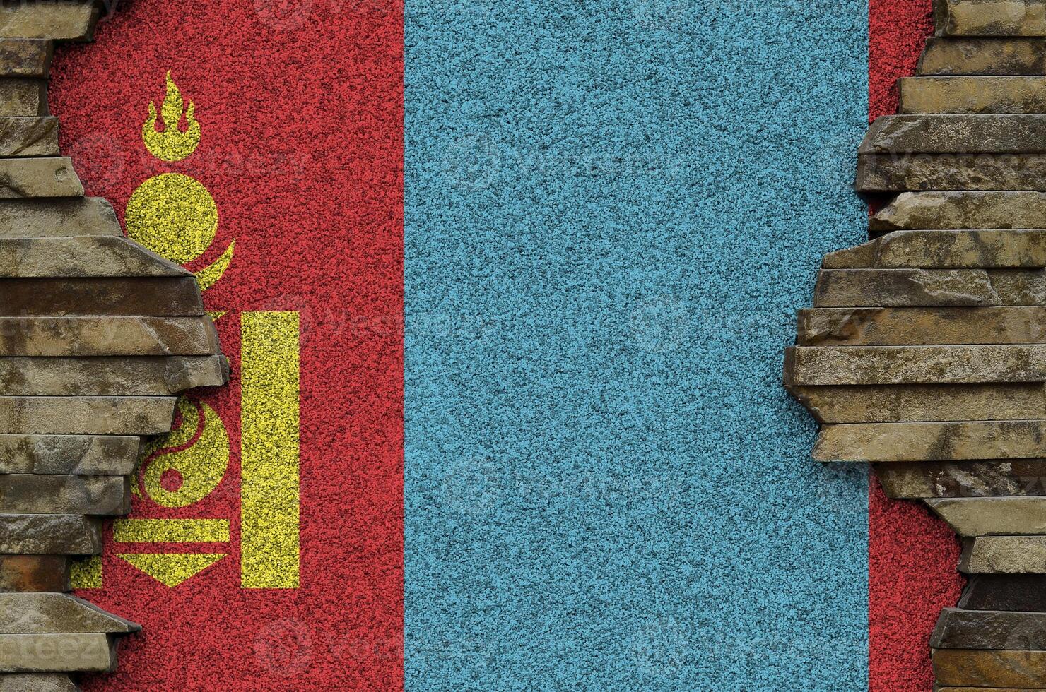 Mongolia flag depicted in paint colors on old stone wall closeup. Textured banner on rock wall background photo