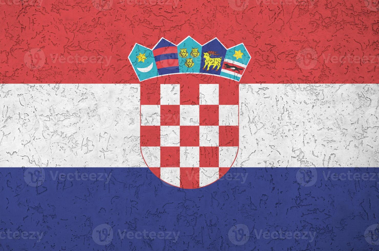 Croatia flag depicted in bright paint colors on old relief plastering wall. Textured banner on rough background photo