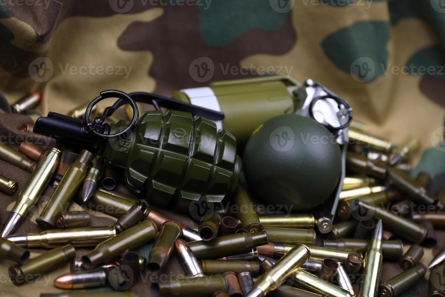 Different types of ammunition on a camouflage background. Preparing for war photo