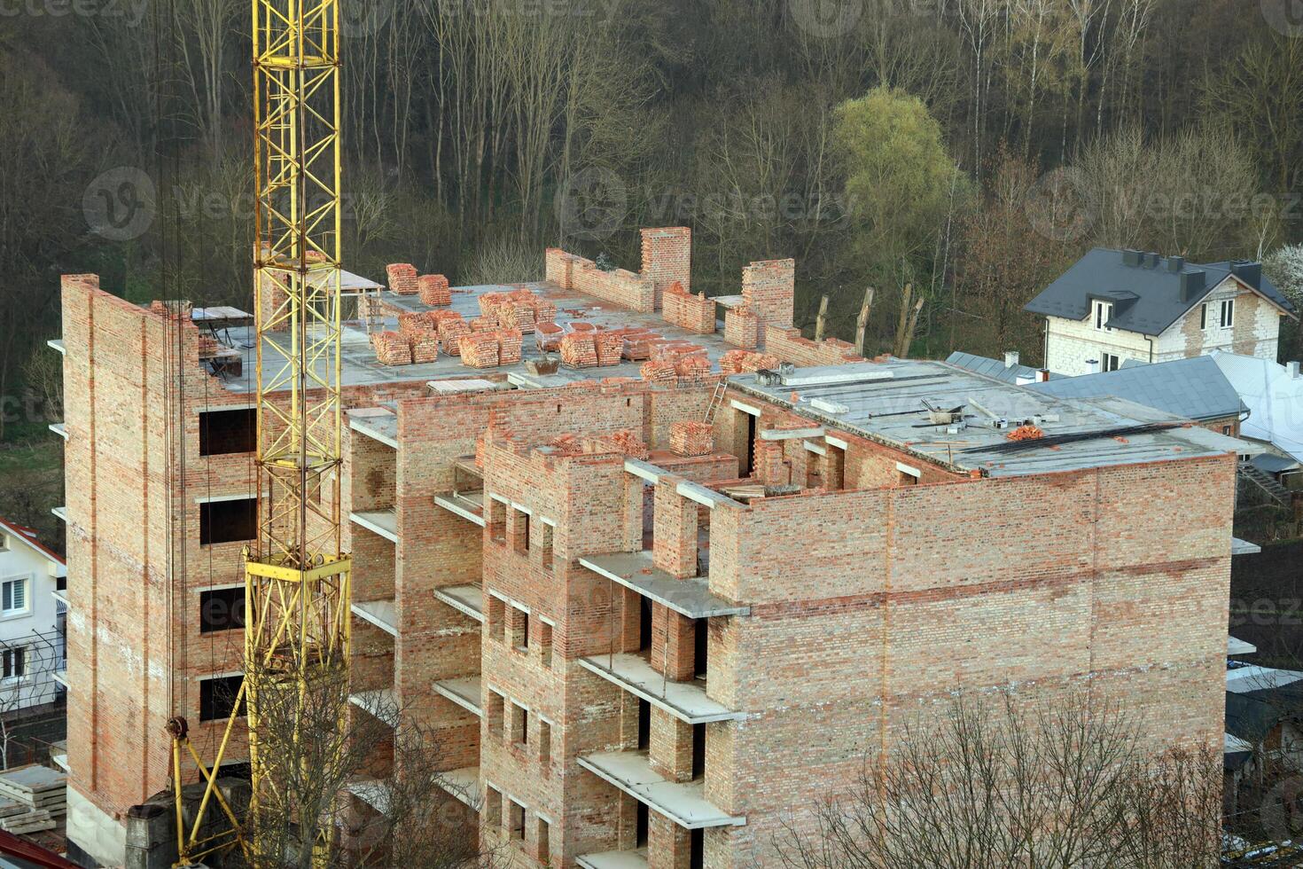 View of a large construction site with buildings under construction and multi-storey residential homes. Housing renovation photo