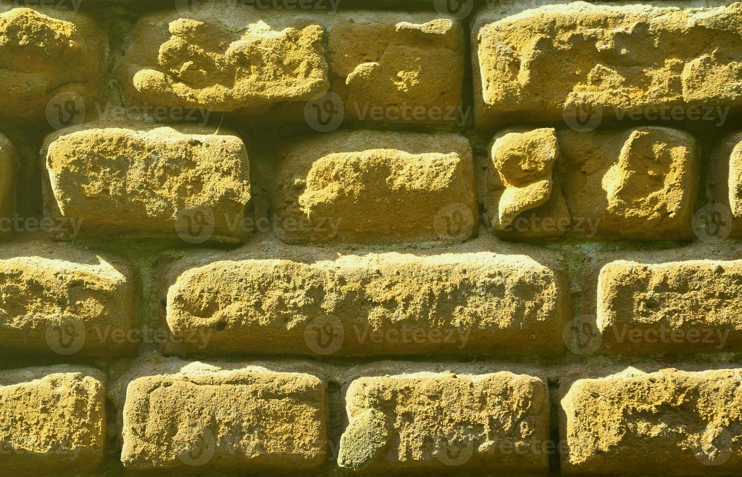 Horizontal wall texture of several rows of very old brickwork made of red brick. Shattered and damaged brick wall with pinched corners photo