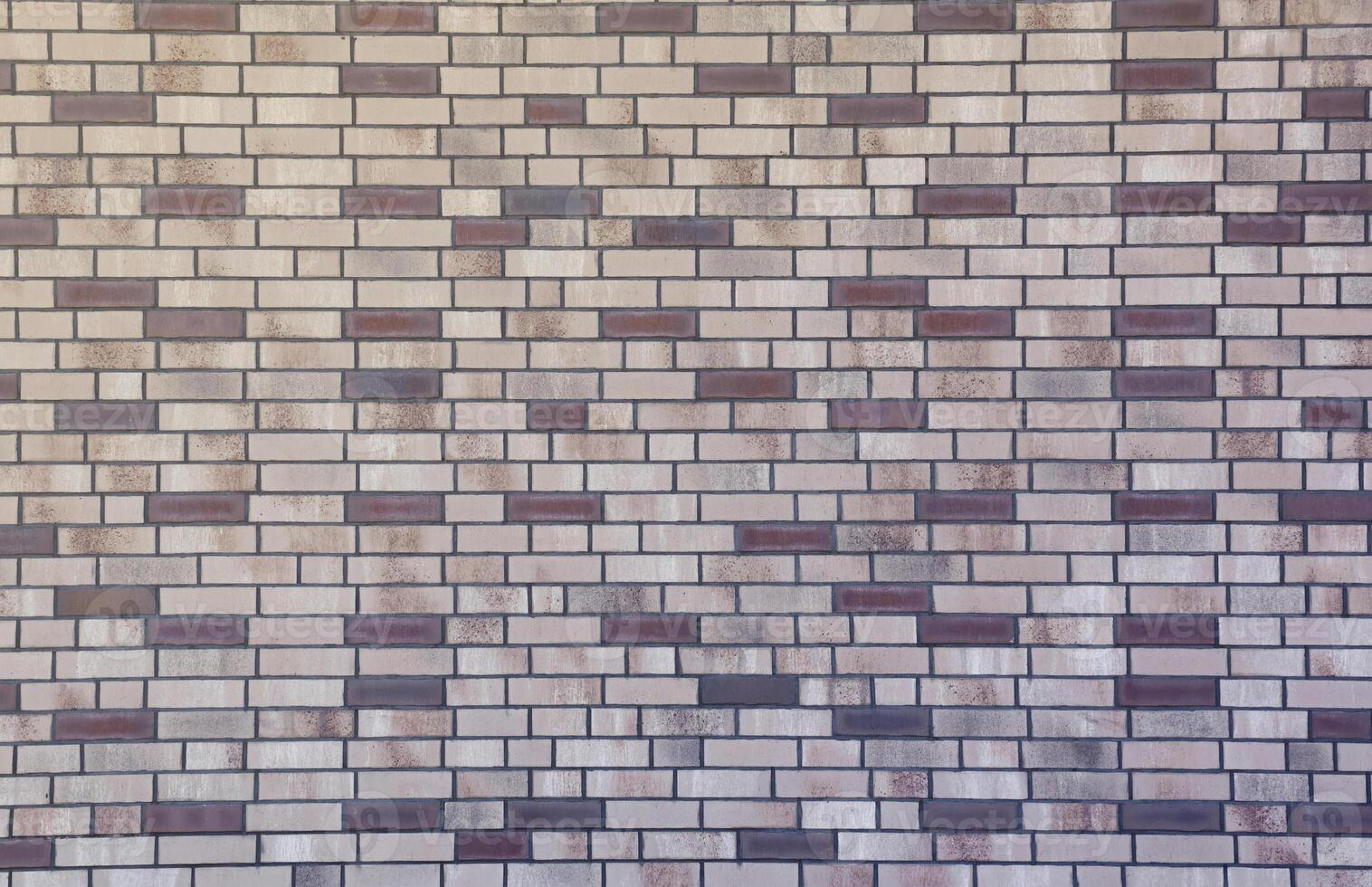 Dark brick wall pattern with chaotic masonry order. Background texture or resource for 3d texturing. Many bricks in big modern stone wall photo