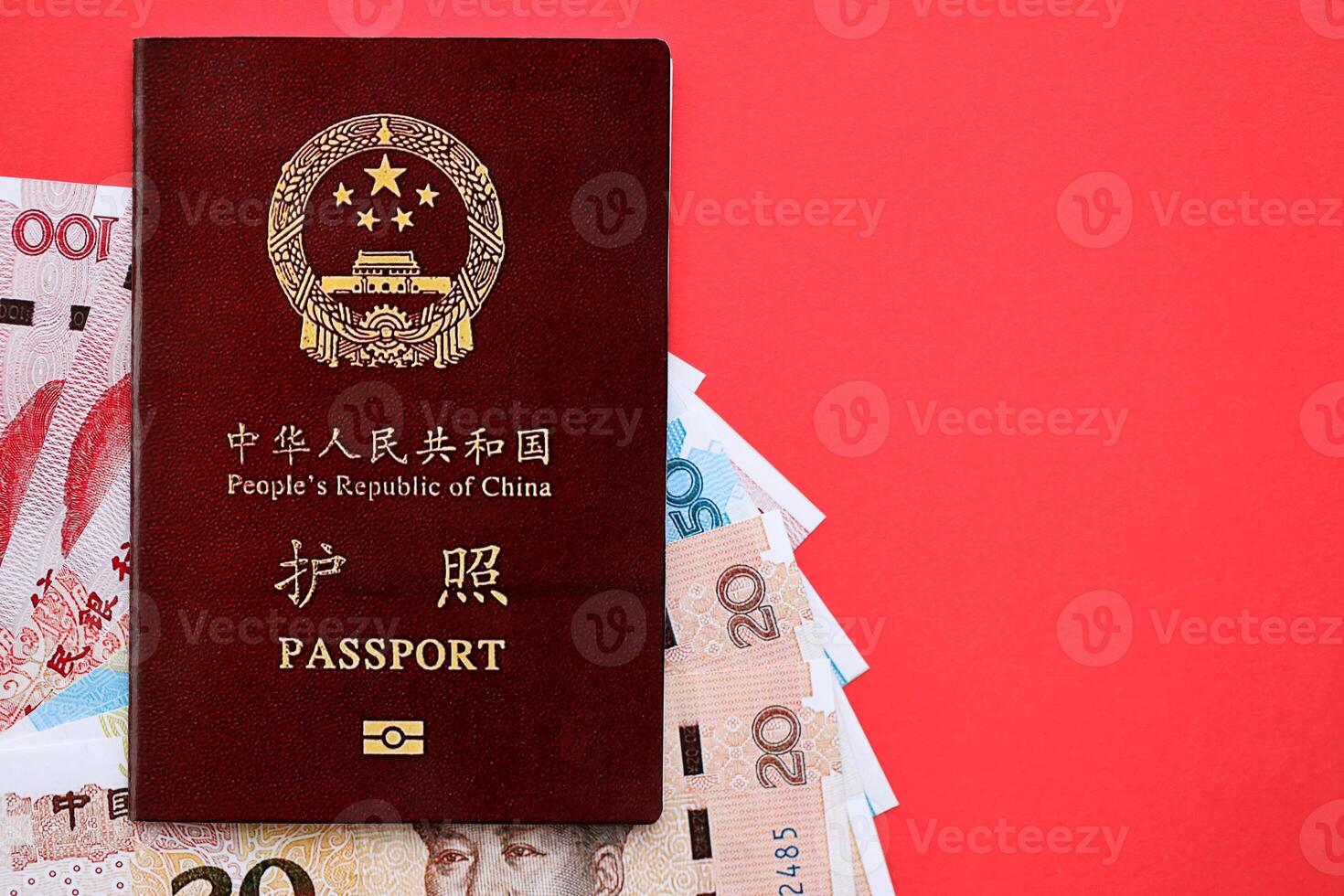 Red passport of People Republic of China and chinese yuan money bills. PRC chinese passport photo