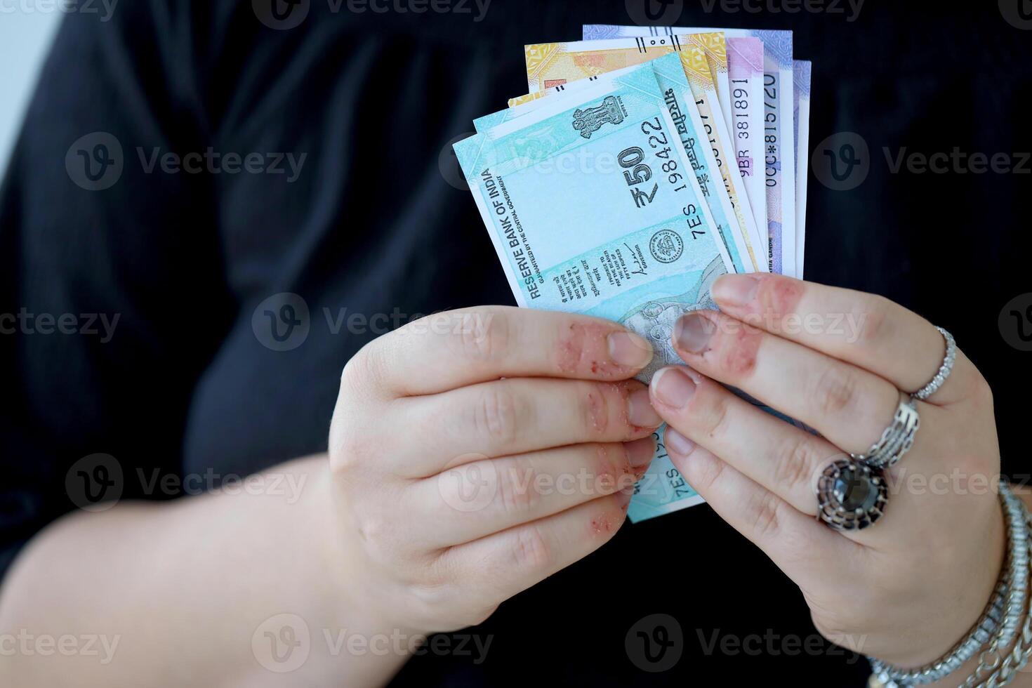 Woman hand with indian rupees bills. Concept of financial operations in cash in India photo