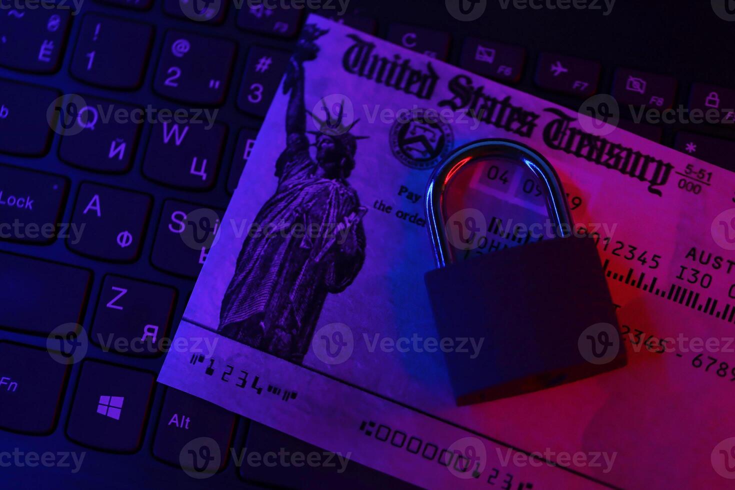 United States Treasury refund check or stimulus bill with small padlock on computer keyboard photo