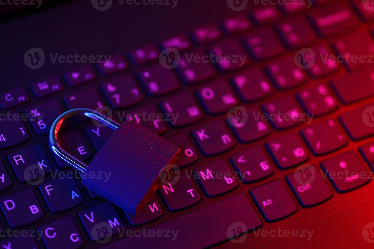 Computer security concept with a closed padlock on the keyboard. Padlock on top of a laptop keyboard. Selective focus photo