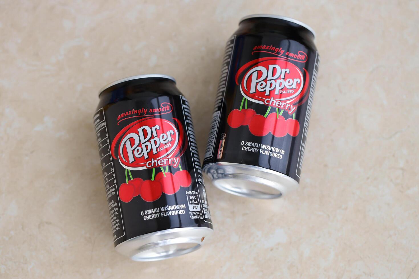 KYIV, UKRAINE - 4 MAY, 2023 Dr Pepper cherry drink black cans photo