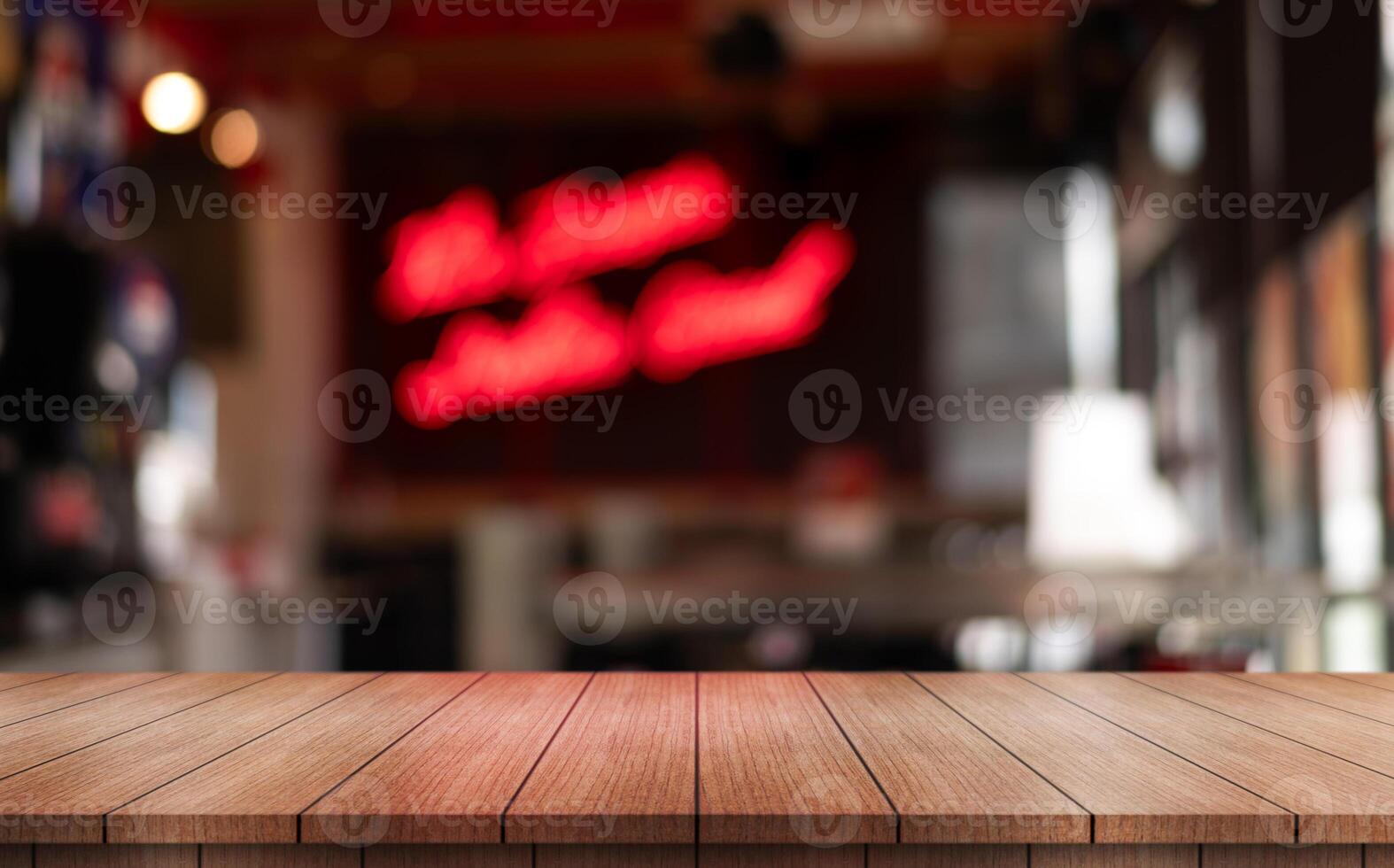 Empty wooden table top with lights bokeh on blur restaurant background photo