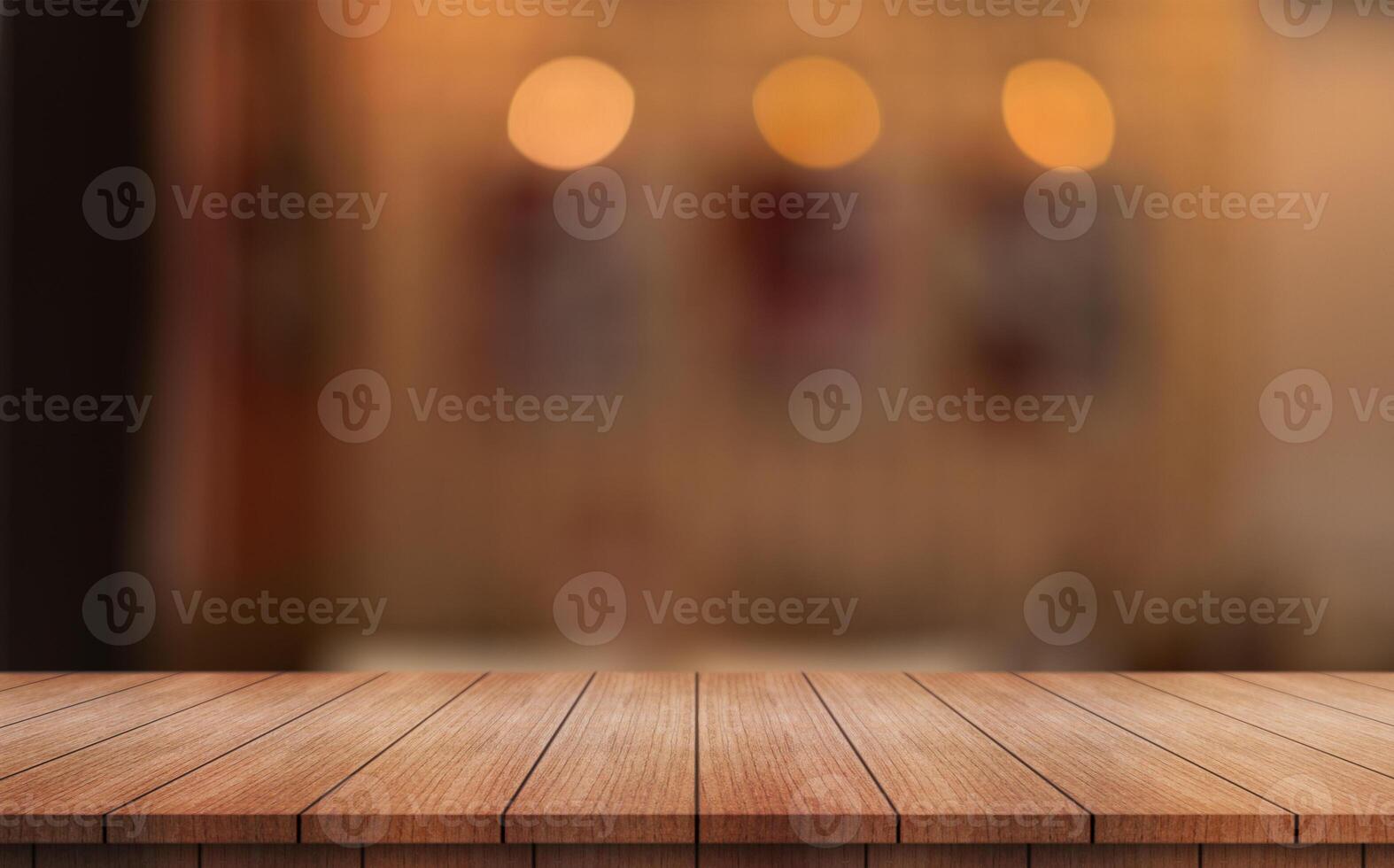 Empty wooden table top with lights bokeh on blur restaurant background photo