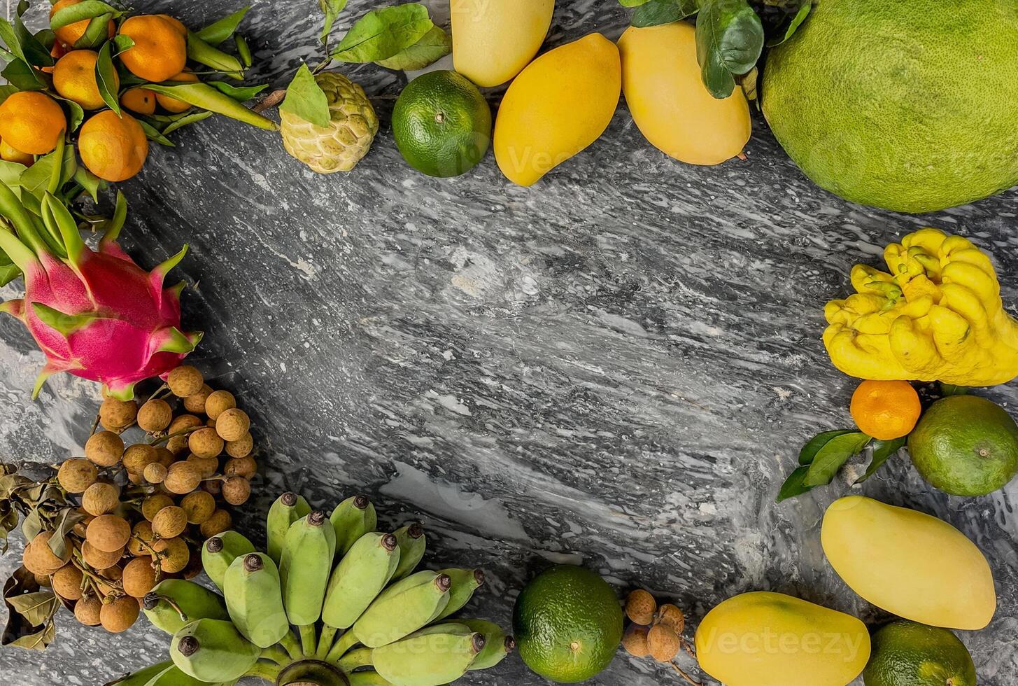 Exotic Fruit Assortment on Grey Stone photo