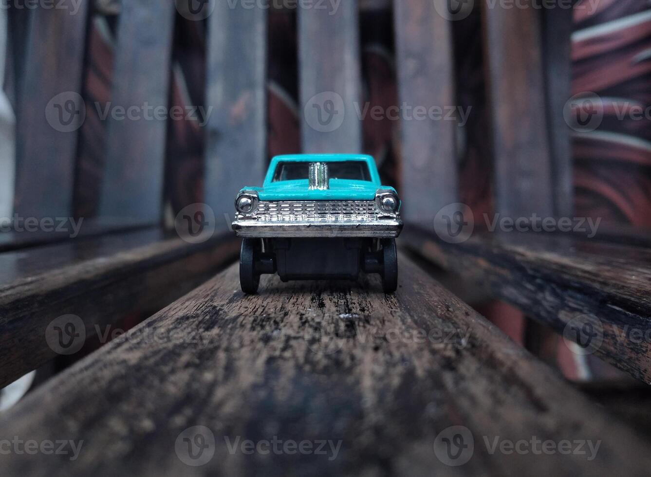 Vintage toy car on wooden background. Selective focus. Shallow depth of field photo
