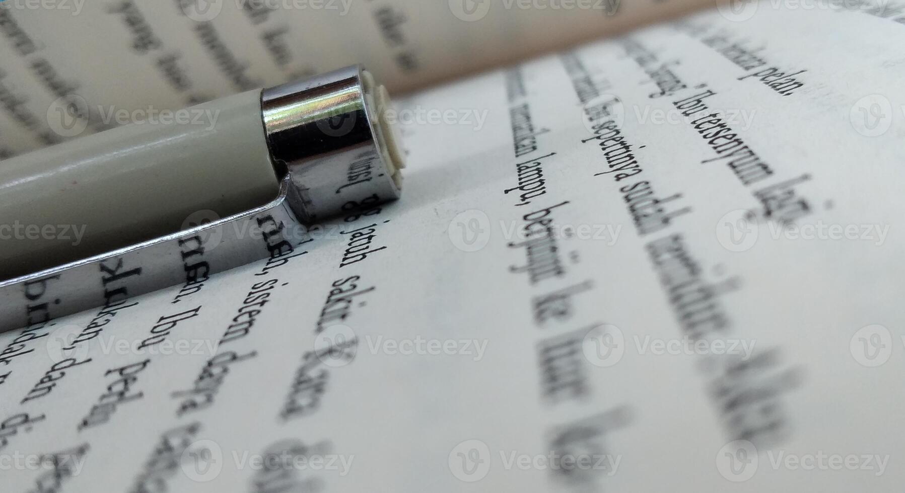 Close-up of a fountain pen on an open book, selective focus photo