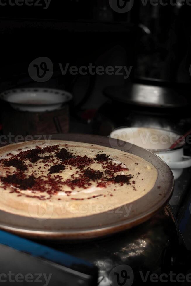 image of sweet crepes covered in sprinkles and chocolate taken at an angle photo