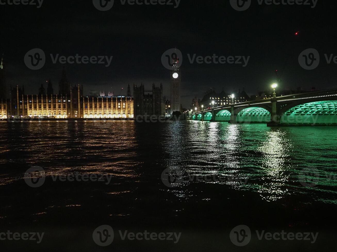 Houses of Parliament and Westminster Bridge at night in London photo