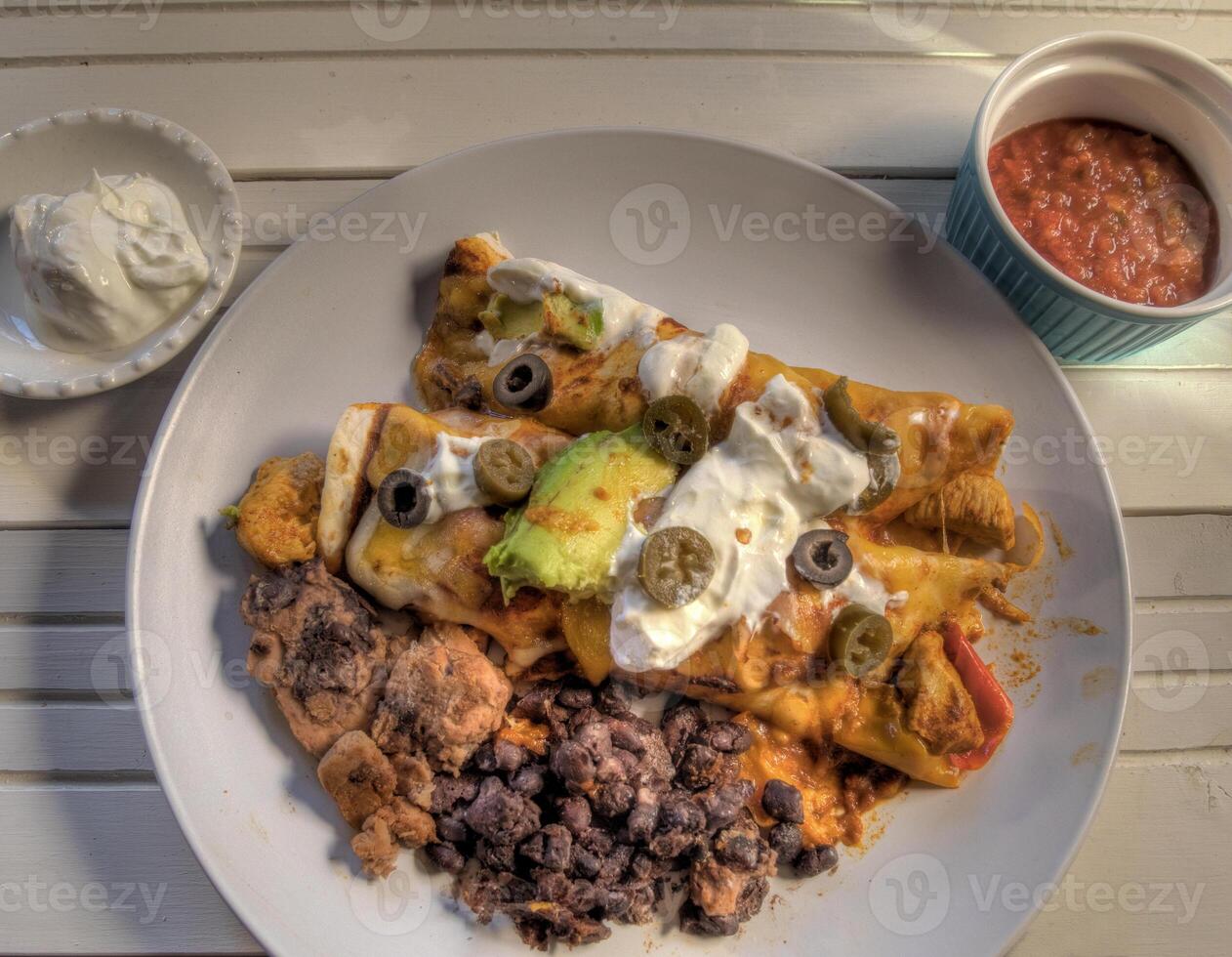 Top View of Chicken Enchiladas on white Natural wood surface photo