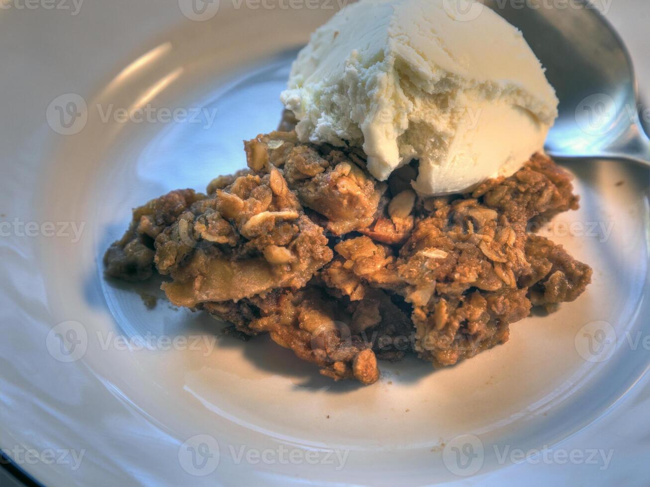 Side View of Vanilla Ice cream on apple crisp photo