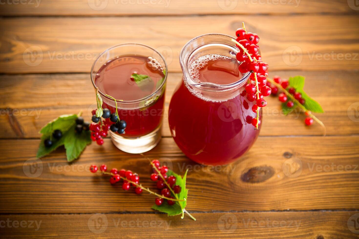 fresh berry juice from red and black currant, on a wooden table photo