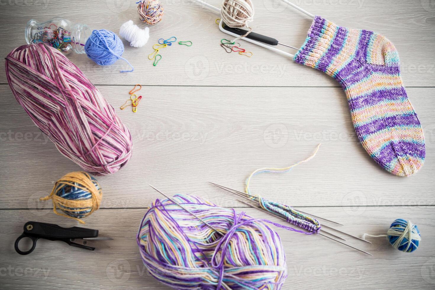 Colored threads, knitting needles and other items for hand knitting photo