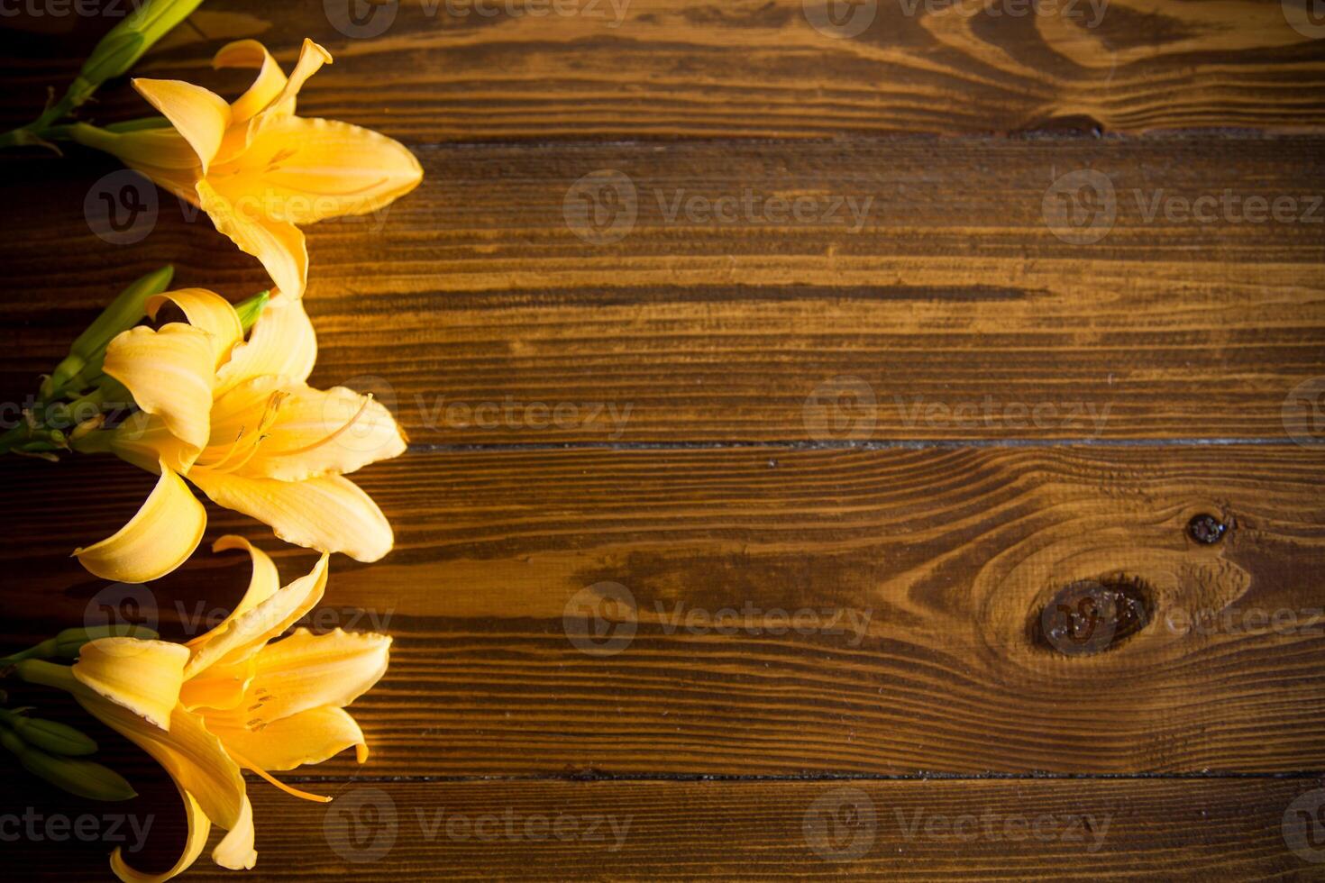 bouquet of beautiful yellow lilies on wooden table photo