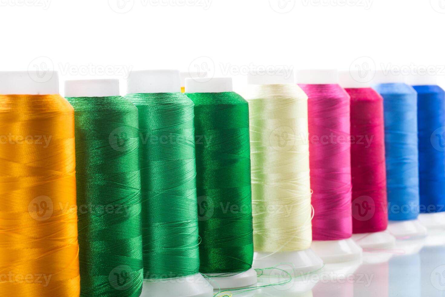 set of different color sewing threads,on white background. photo