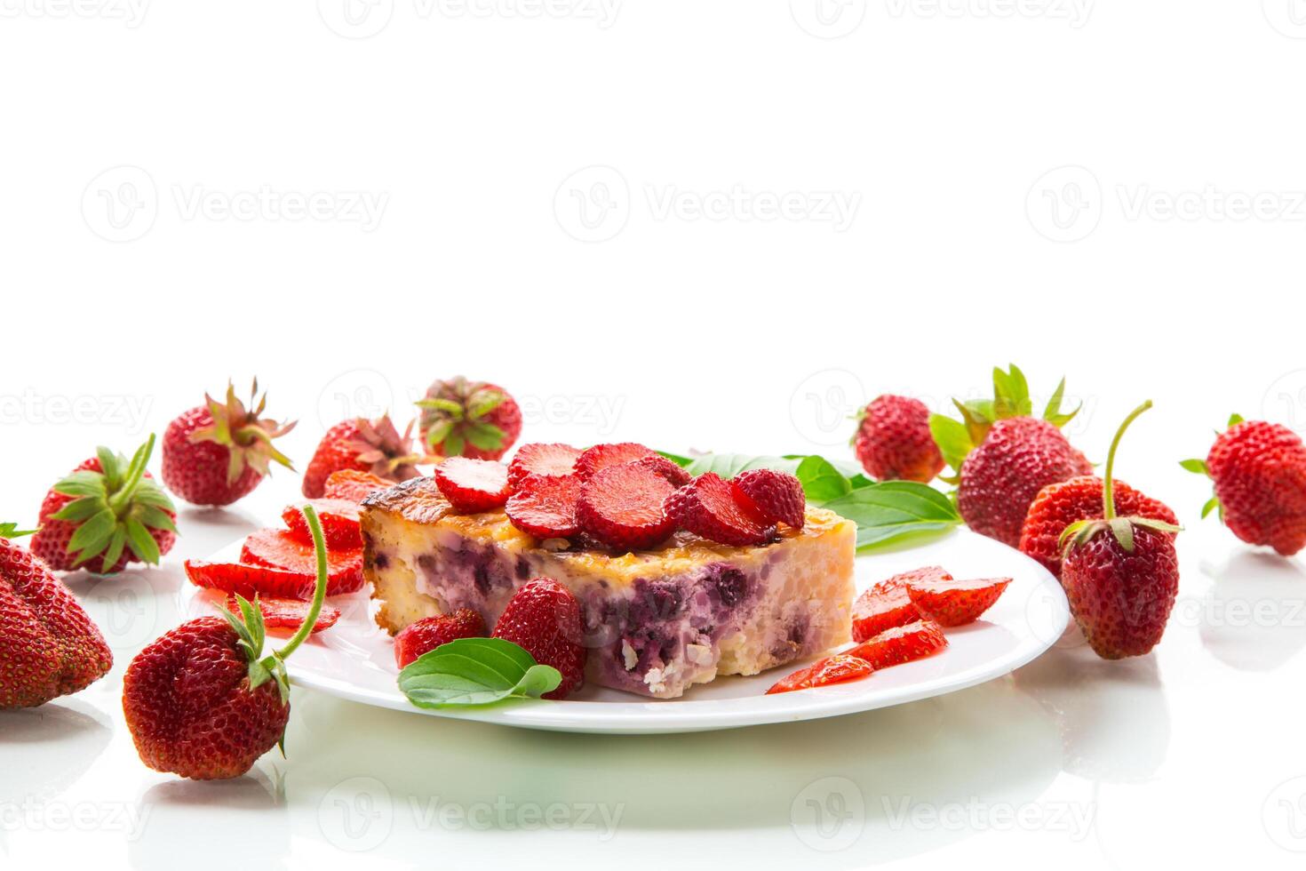 cooked cottage cheese casserole with berry and strawberry filling in a plate photo