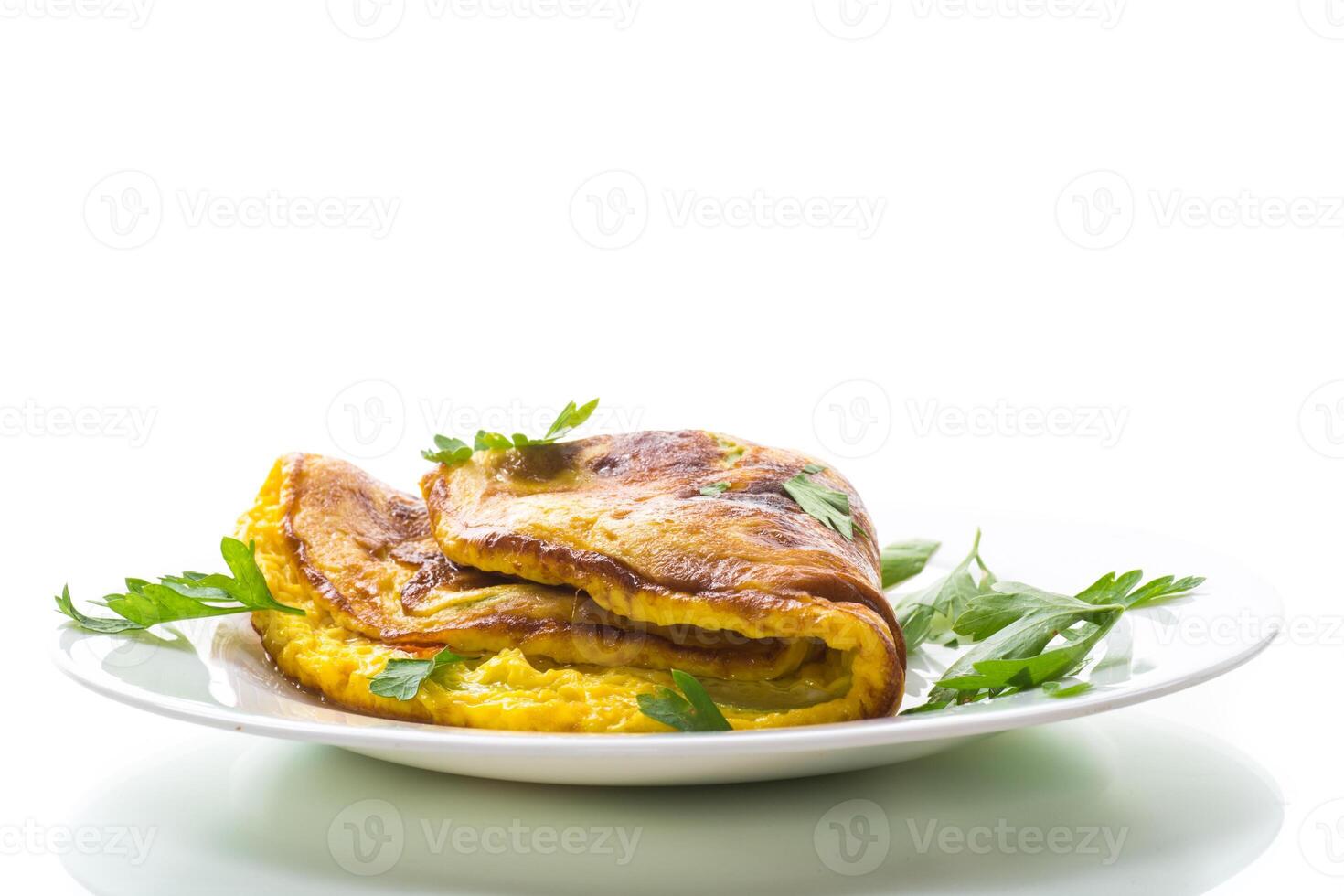 Fried omelette with zucchini,in a plate on a white background. photo