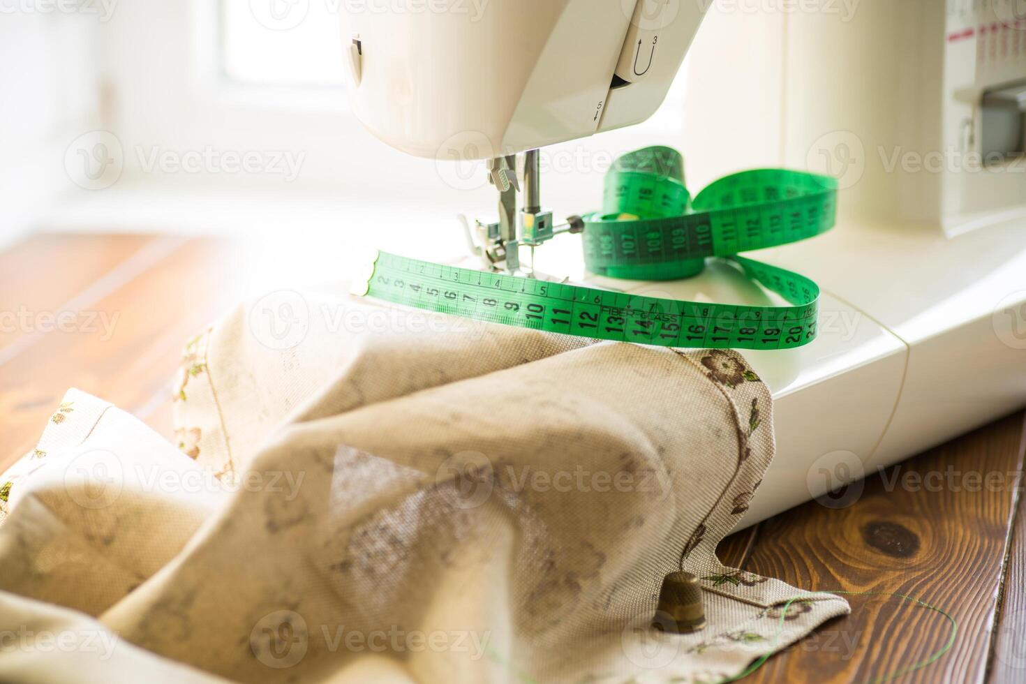 Sewing machine with fabric and threads for sewing, close-up. The working process photo