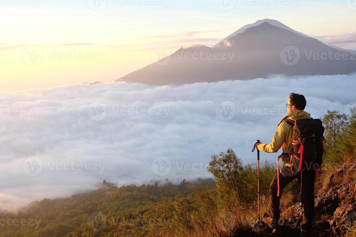 Peak Paradise, Asian Model on Mount Batur Summit with Ocean of Clouds under Azure Sky photo