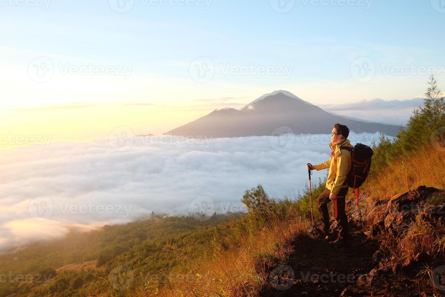Peak Paradise, Asian Model on Mount Batur Summit with Ocean of Clouds under Azure Sky photo