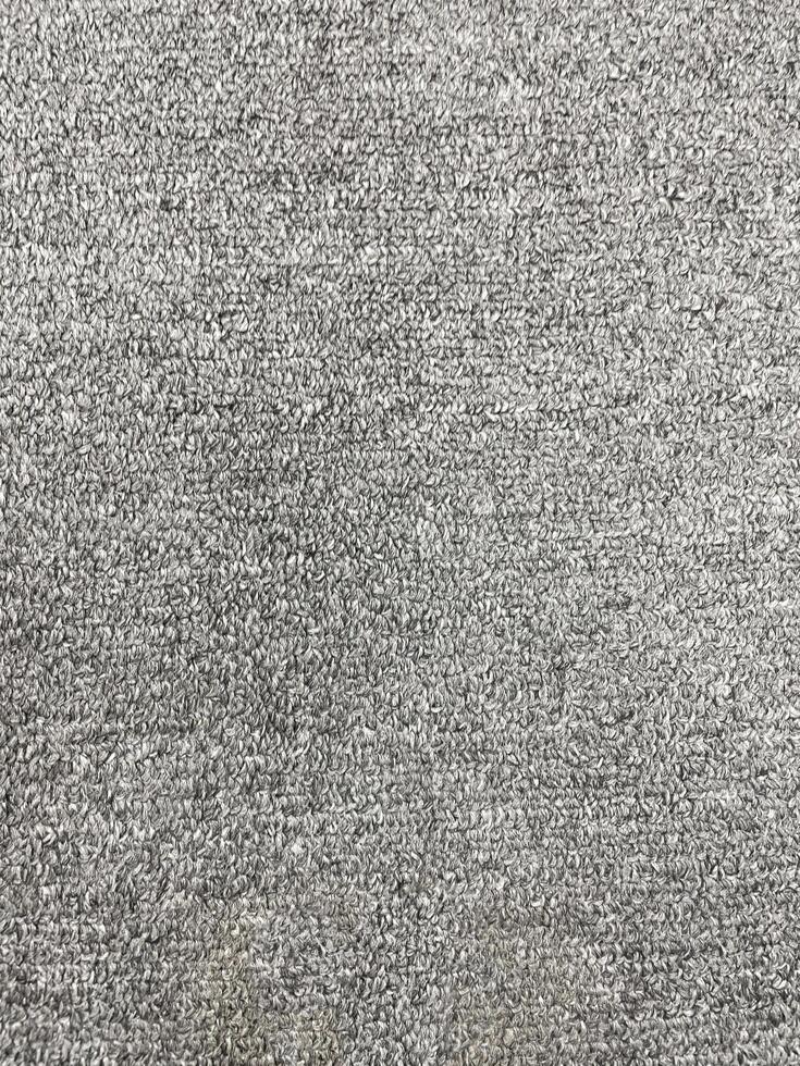 Seamless close up of monochrome grey carpet texture background from above. photo