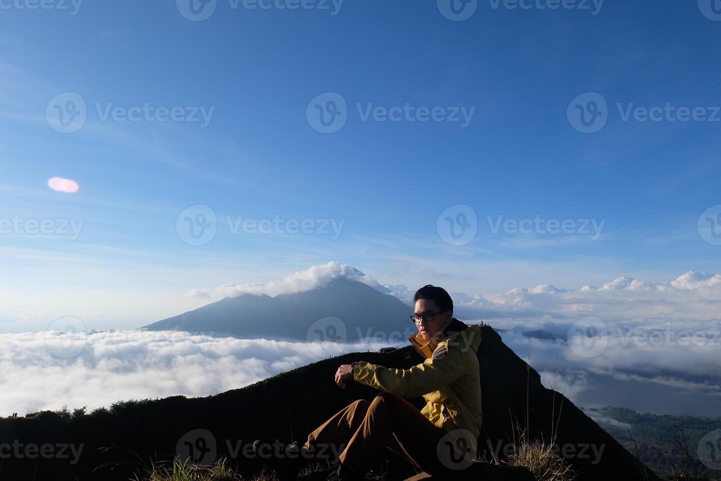 Peak Paradise, Asian Model on Mount Batur Summit with Ocean of Clouds under Azure Sky photo