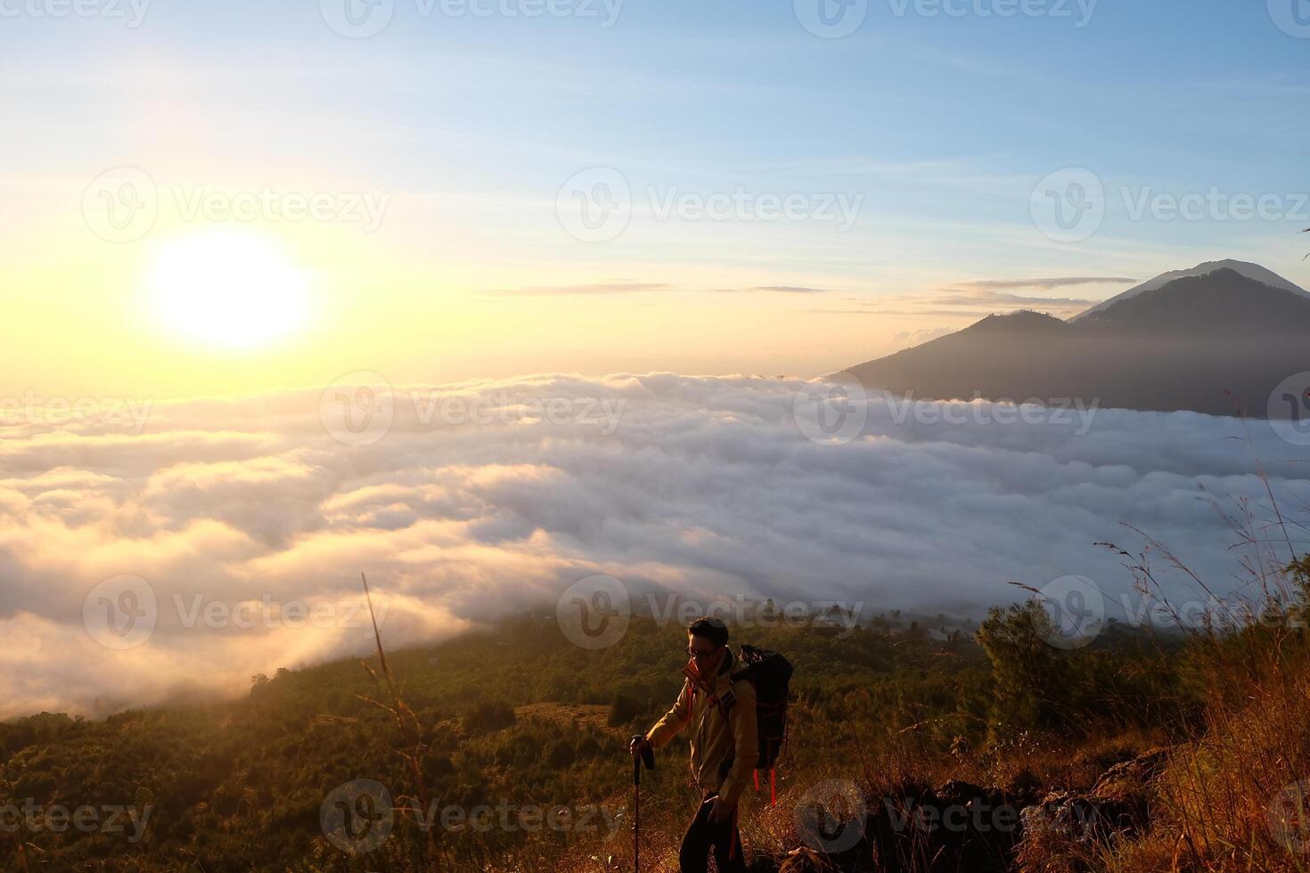 Peak Paradise, Asian Model on Mount Batur Summit with Ocean of Clouds under Azure Sky photo