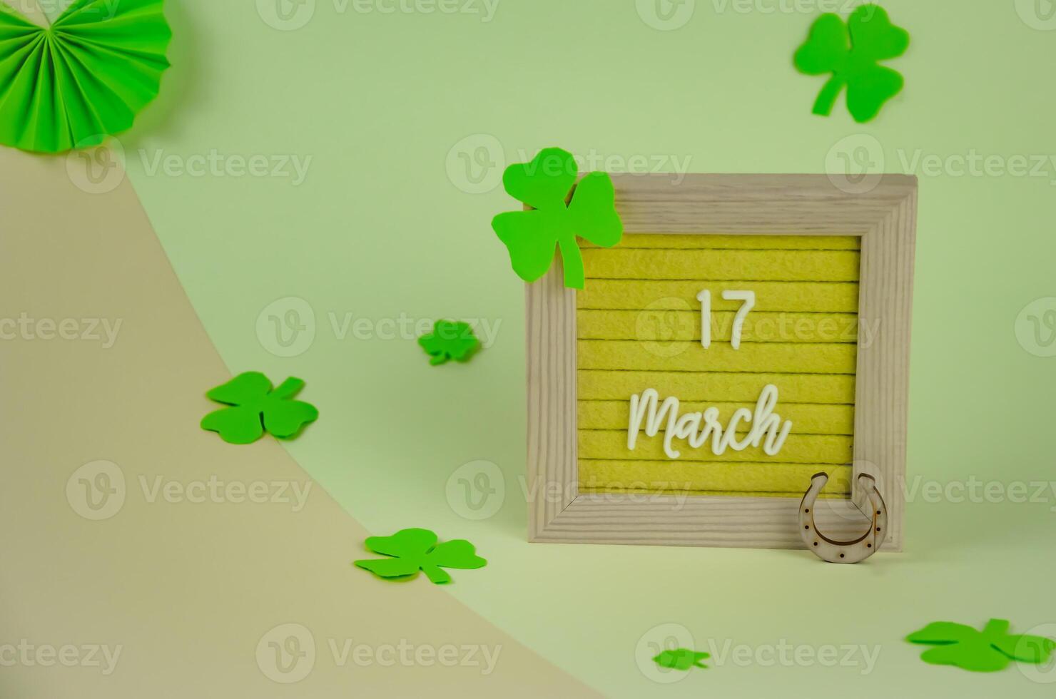 St. Patrick's Day holiday concept, date and clover on background photo