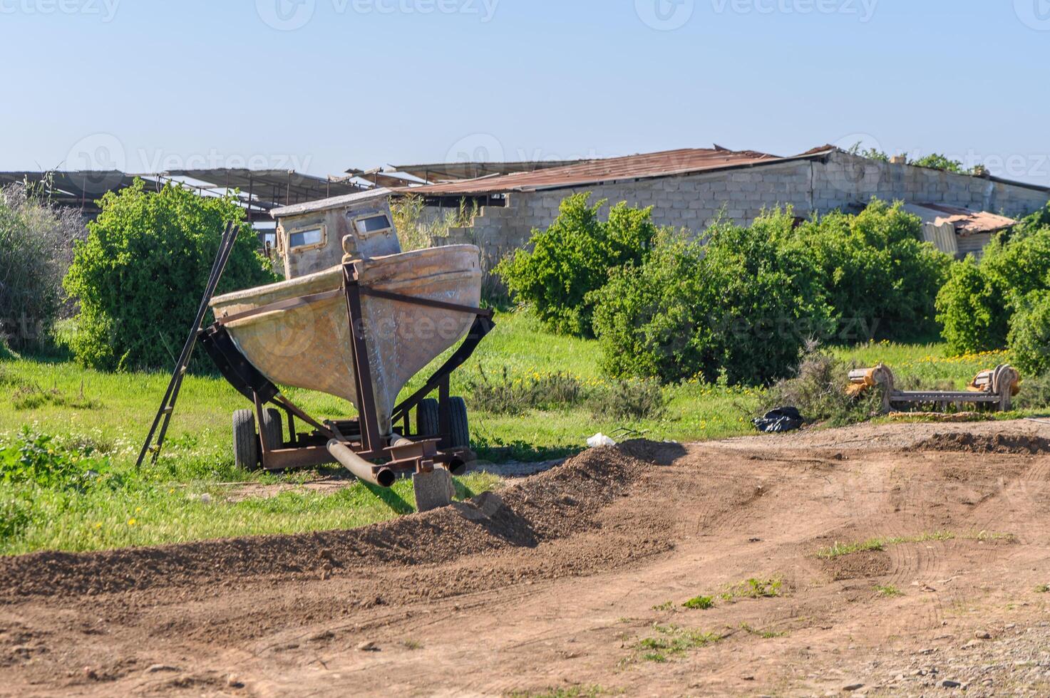 old fishing boat in front of a village house 1 photo