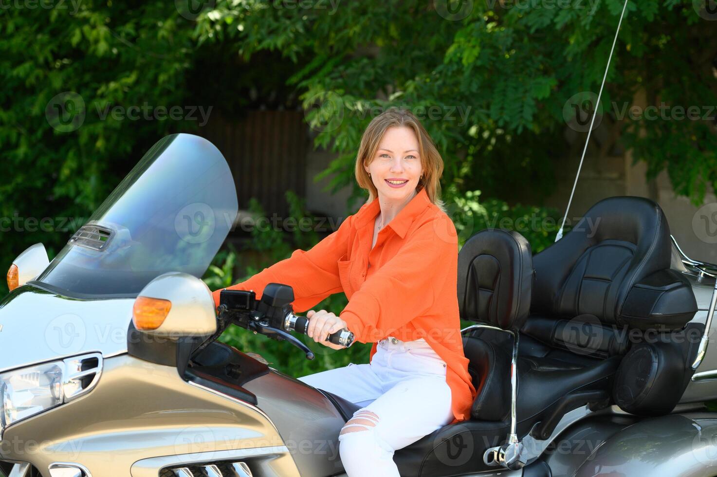 portrait of a young beautiful girl on a motorcycle 1 photo