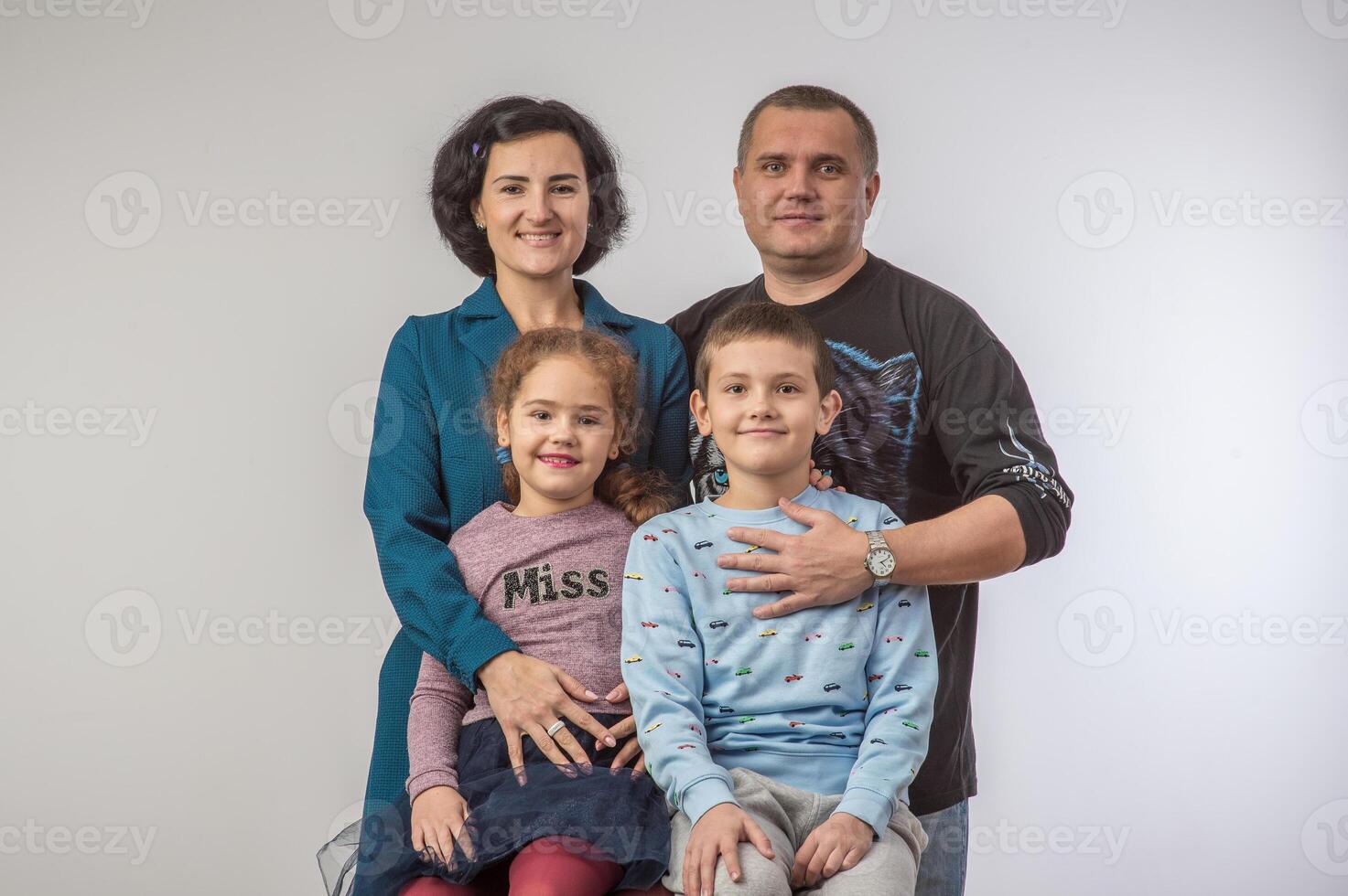 studio portrait of a happy family husband wife daughter and son 7 photo