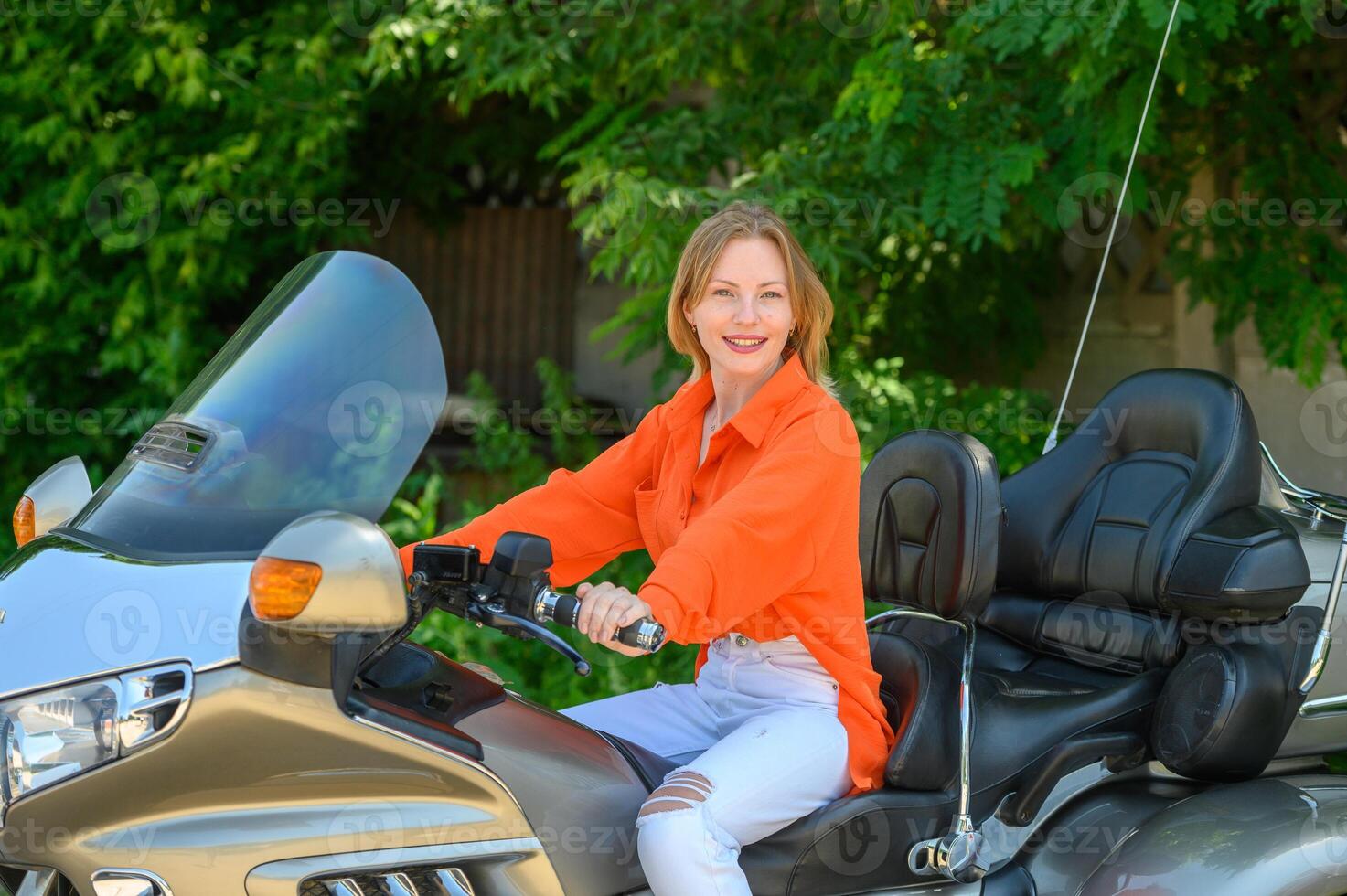 portrait of a young beautiful girl on a motorcycle 2 photo