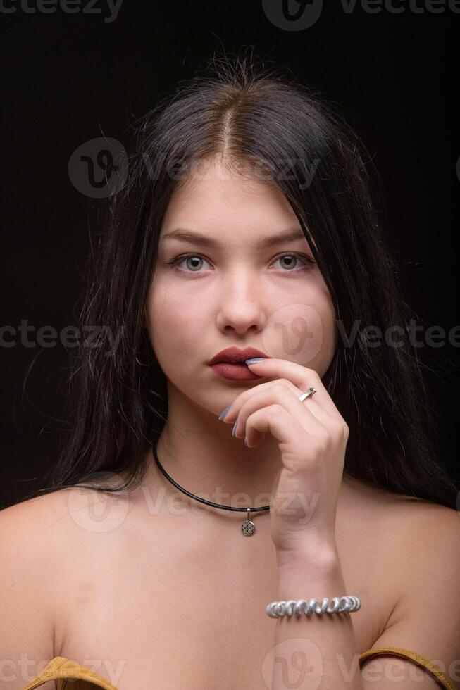 Studio portrait of a young beautiful girl with long hair 1 photo