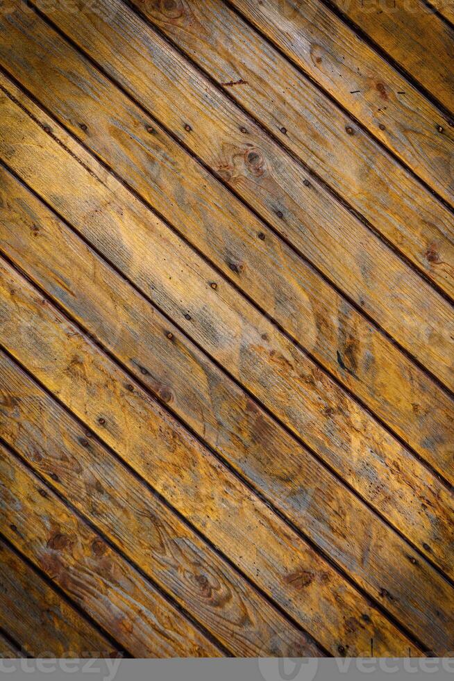 Wooden wall made of diagonal boards with light brown stripes. Background.2 photo